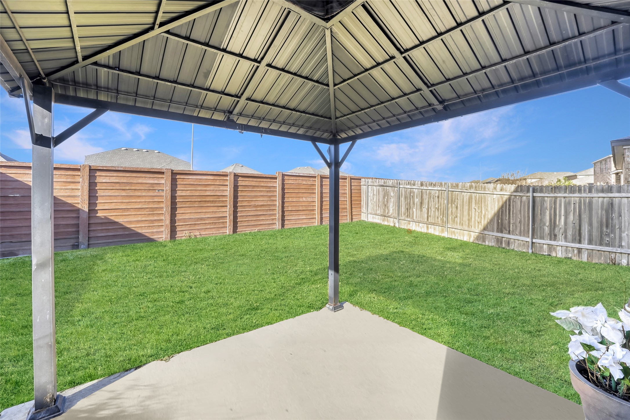 13604 Vigilance Street Manor, TX 78653 - Photo 26 of 28 a view of a backyard with wooden fence