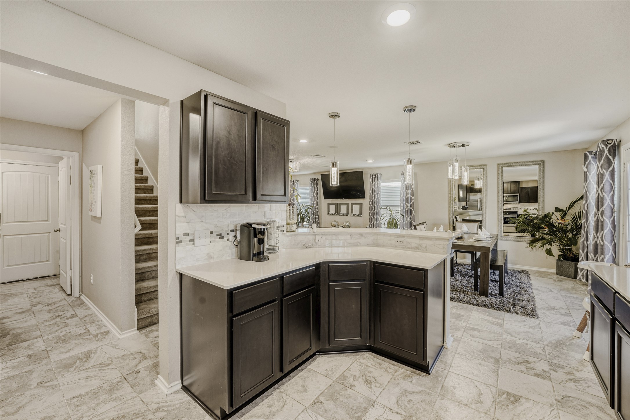 13604 Vigilance Street Manor, TX 78653 - Photo 8 of 28 a kitchen with kitchen island sink cabinets and stainless steel appliances