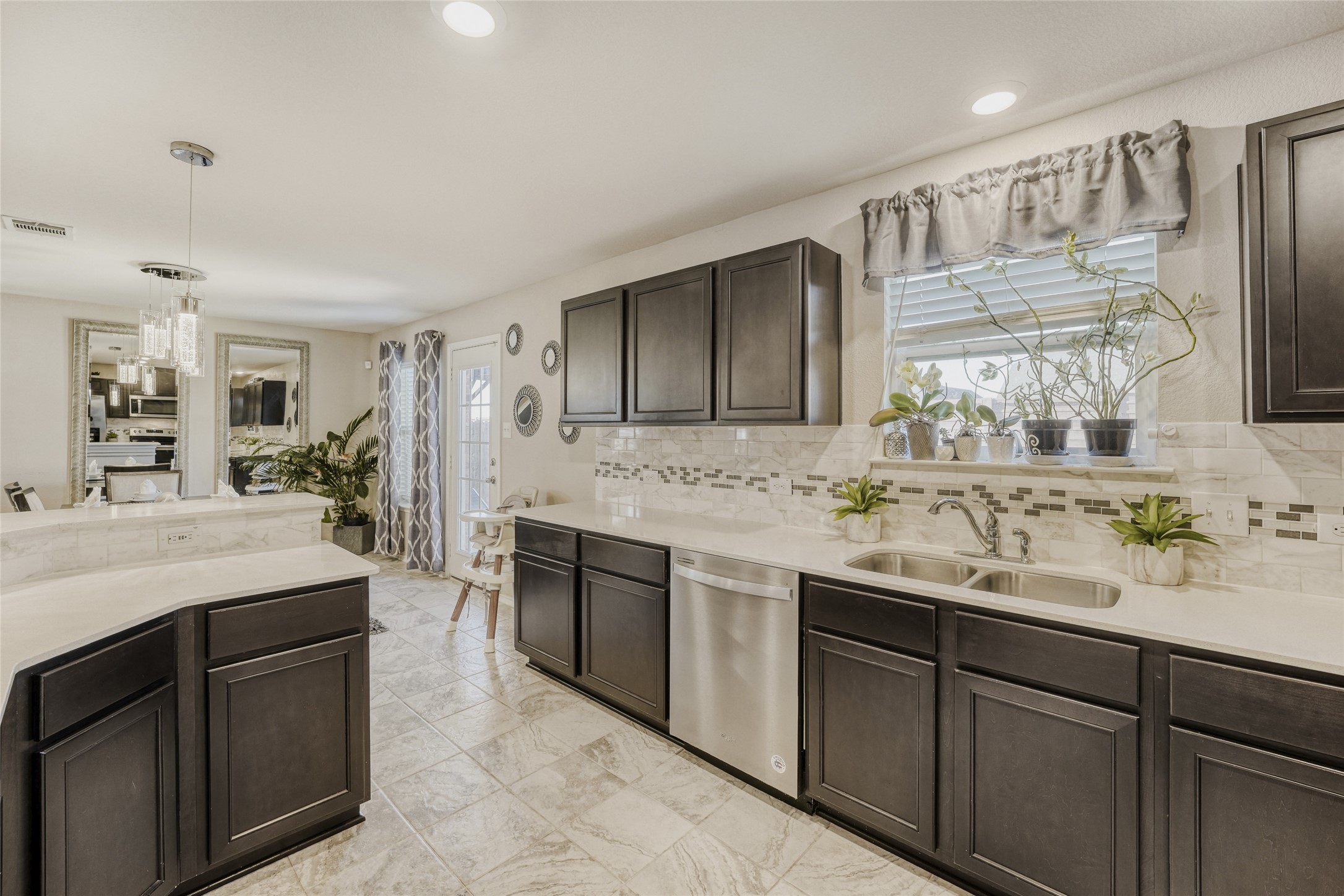 13604 Vigilance Street Manor, TX 78653 - Photo 9 of 28 a spacious bathroom with a sink double vanity granite and a mirror