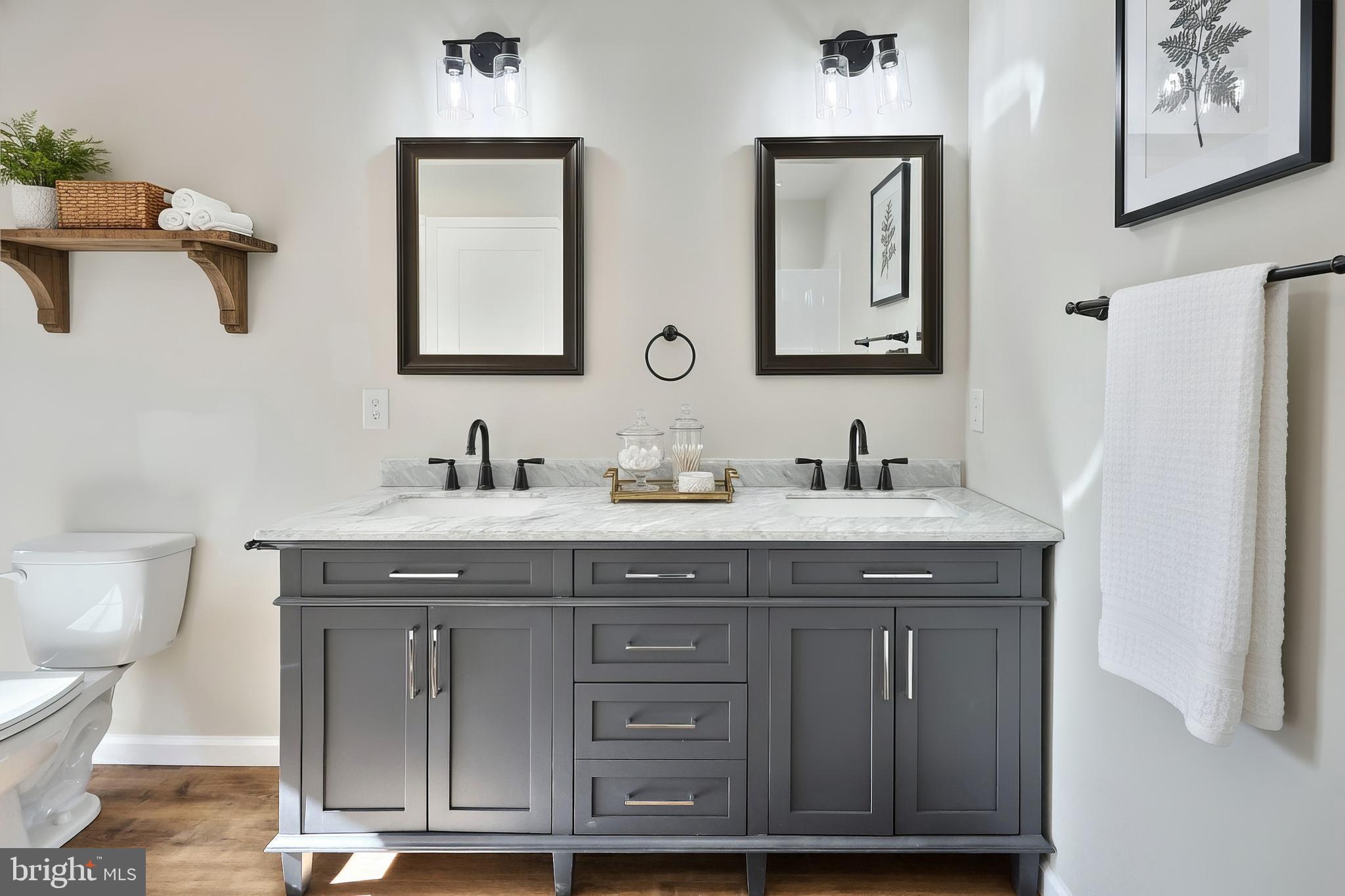 10640 Enfield Road Felton, PA 17322 - Photo 22 of 59 a bathroom with a granite countertop toilet sink and mirror