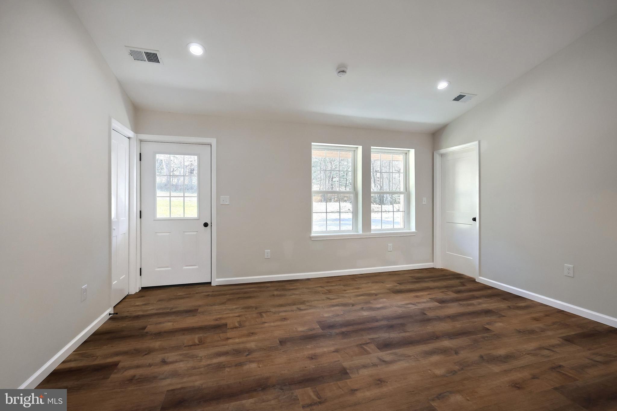 10640 Enfield Road Felton, PA 17322 - Photo 37 of 59 an empty room with wooden floor and windows