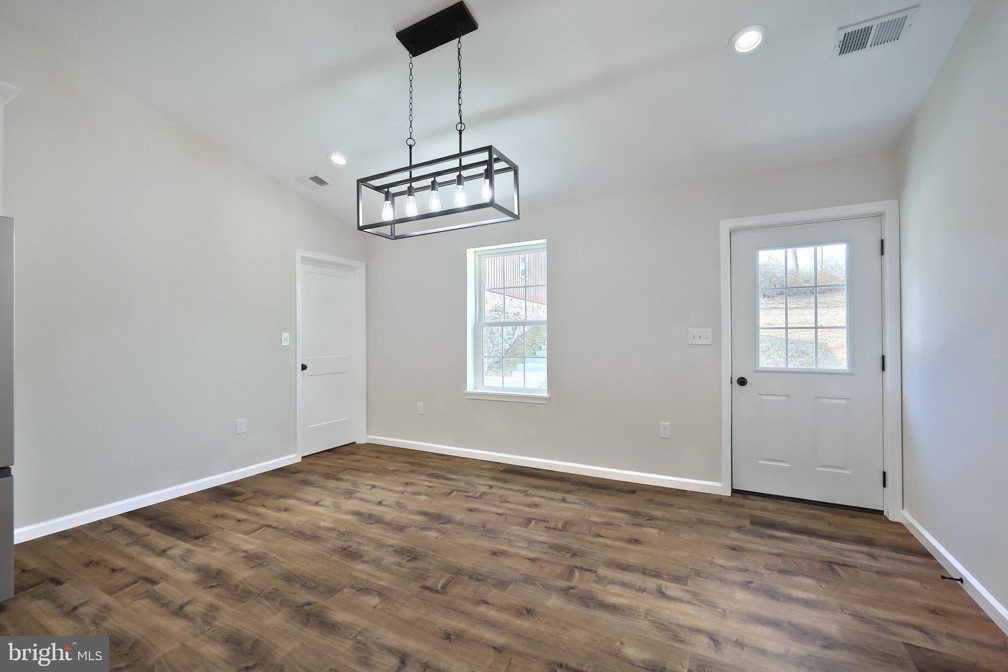 10640 Enfield Road Felton, PA 17322 - Photo 40 of 59 a view of empty room with wooden floor and ceiling fan