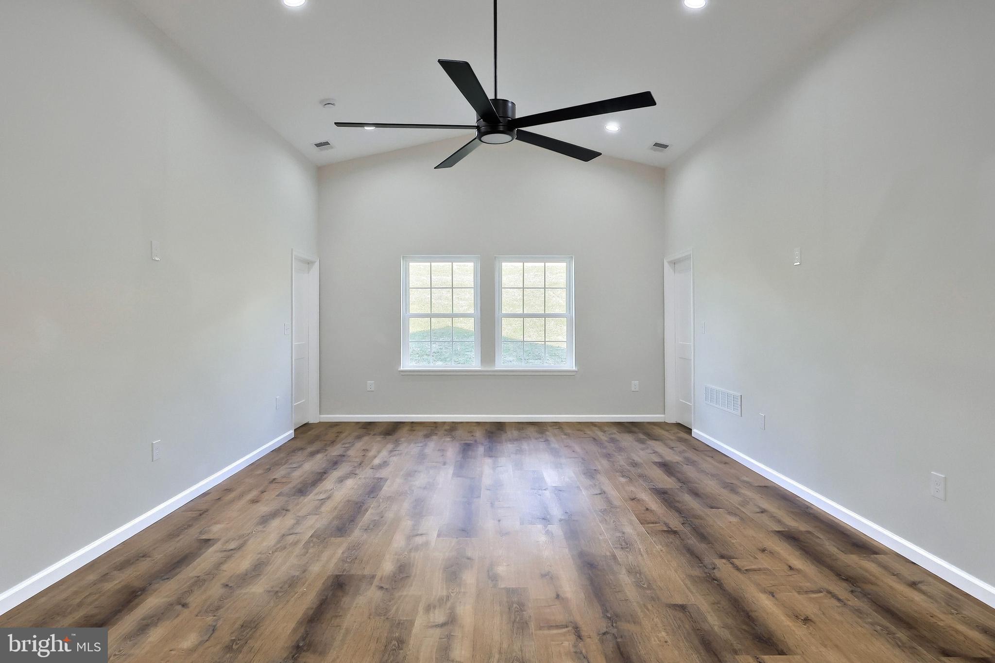 10640 Enfield Road Felton, PA 17322 - Photo 42 of 59 an empty room with wooden floor fan and windows