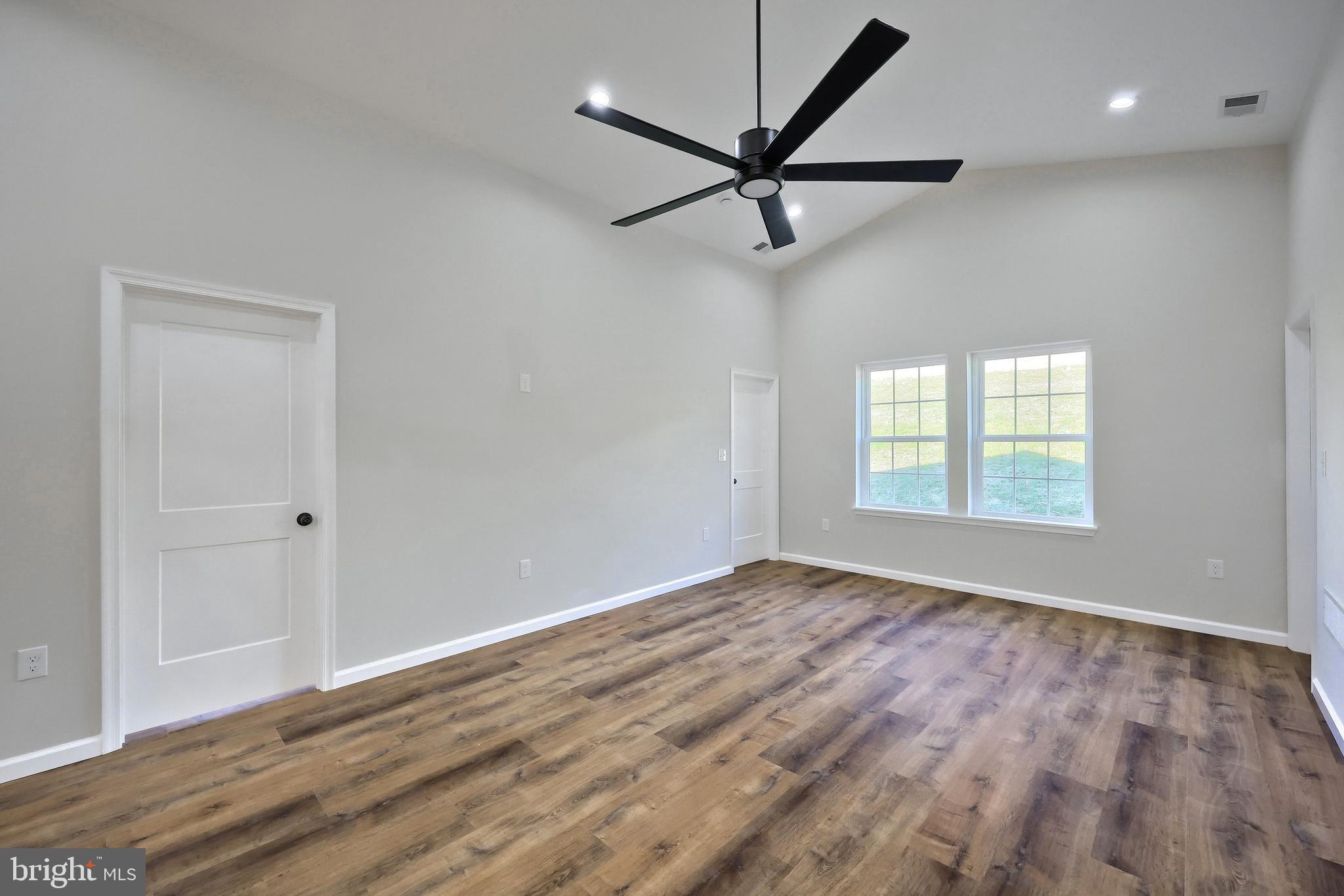 10640 Enfield Road Felton, PA 17322 - Photo 44 of 59 a view of a big room with wooden floor closet and windows