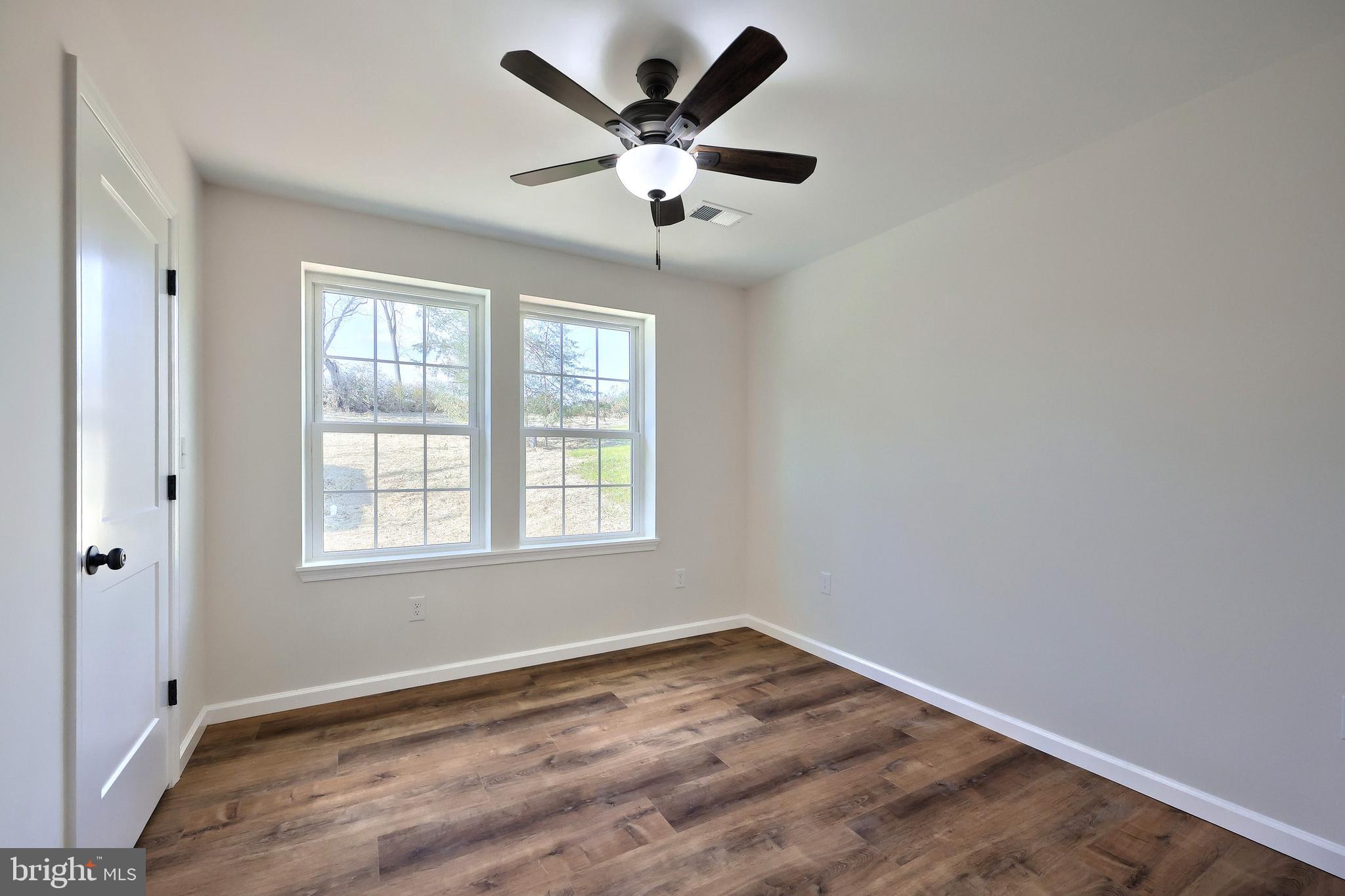 10640 Enfield Road Felton, PA 17322 - Photo 45 of 59 an empty room with wooden floor and windows