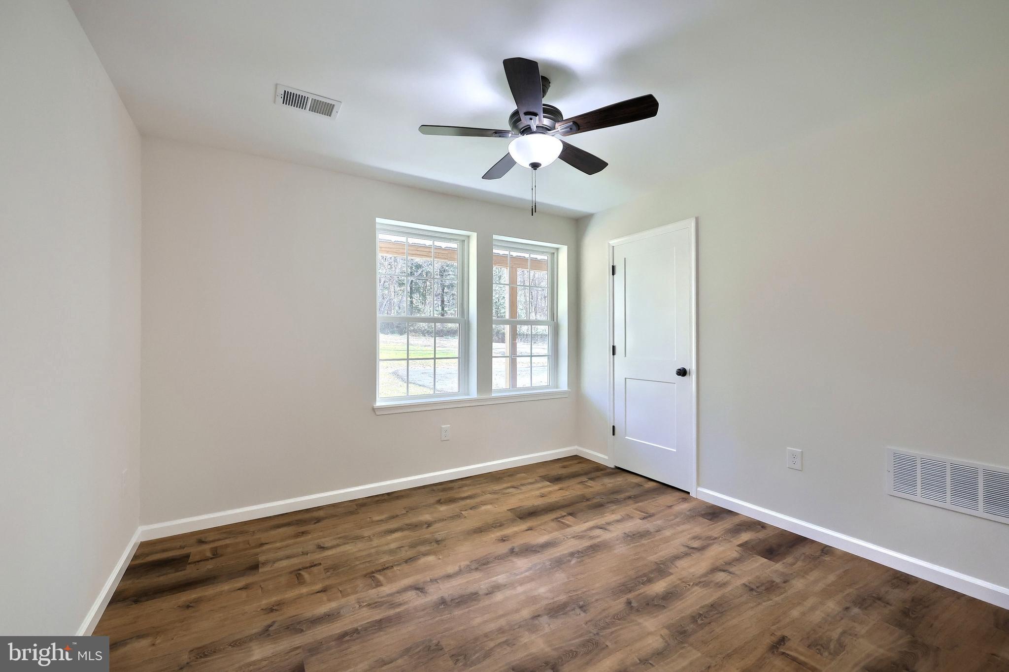 10640 Enfield Road Felton, PA 17322 - Photo 48 of 59 a view of empty room with wooden floor and fan