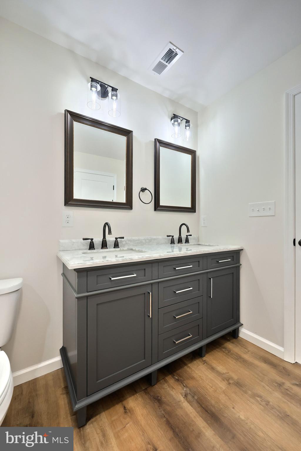 10640 Enfield Road Felton, PA 17322 - Photo 50 of 59 a spacious bathroom with a sink and a mirror