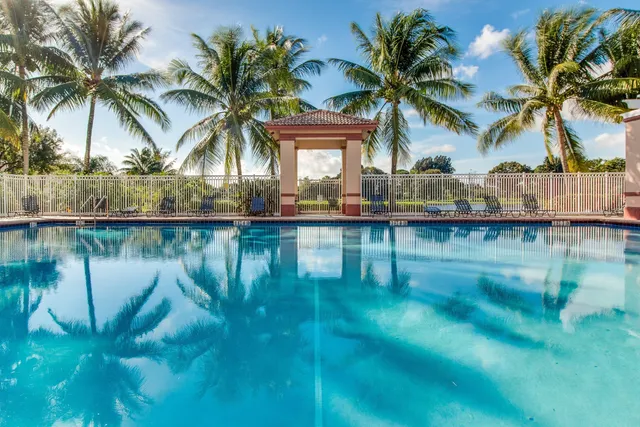 a view of a dining room with furniture and large windows