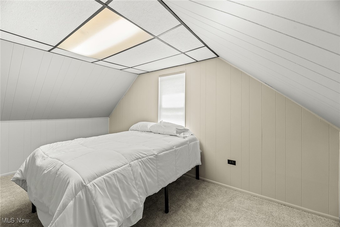 430 Stanley Road Akron, OH 44312 - Photo 20 of 36 Carpeted bedroom featuring lofted ceiling and wood walls