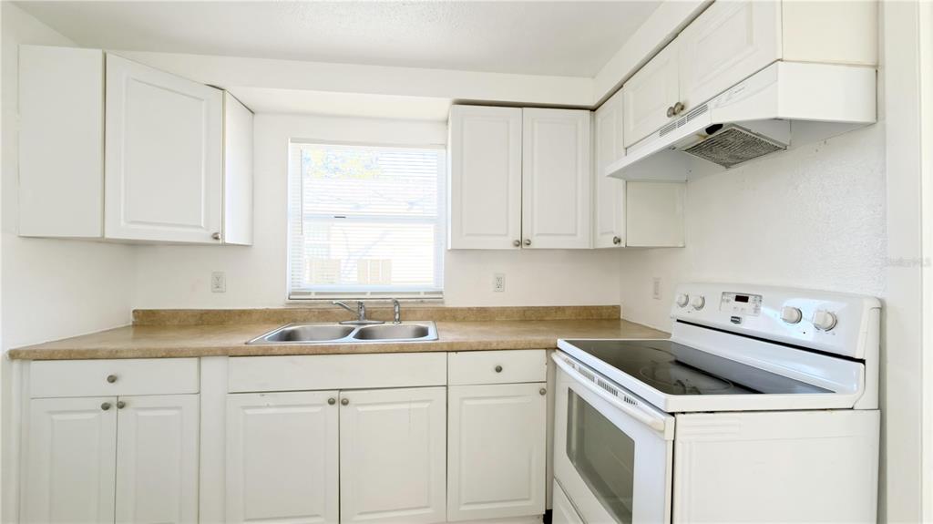 8204 North Semmes Street Tampa, FL 33604 - Photo 5 of 14 a kitchen with a sink stove and cabinets