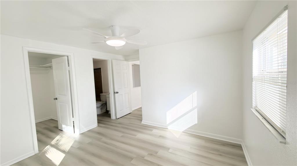 8204 North Semmes Street Tampa, FL 33604 - Photo 10 of 14 a view of empty room with wooden floor and fan