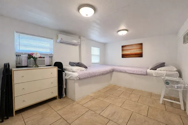 a room with a washing machine and a chair