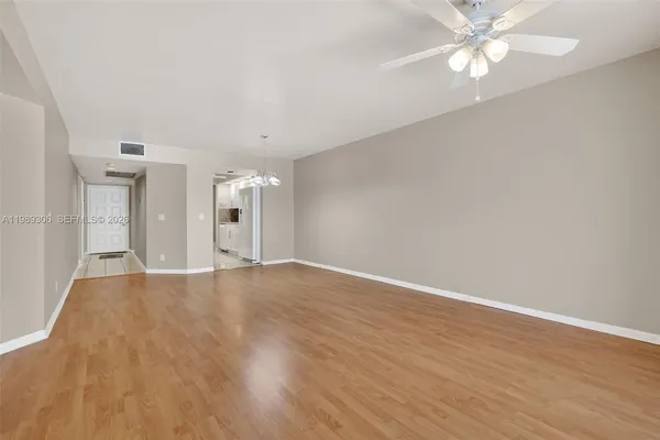 a view of empty room with wooden floor