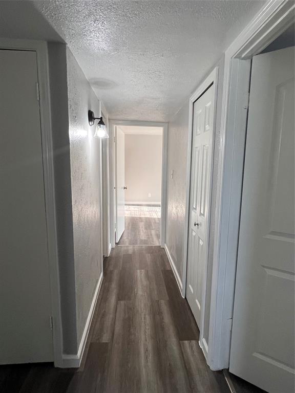 8506 Woodside Road Rowlett, TX 75088 - Photo 12 of 27 a view of a hallway with wooden floor