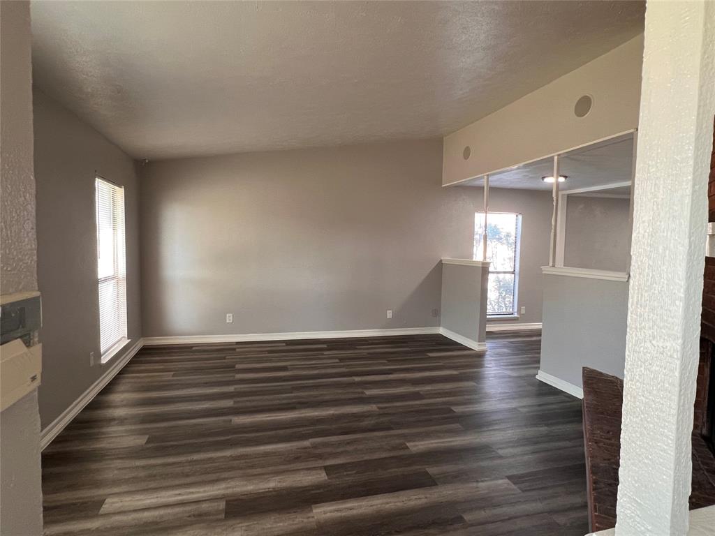 8506 Woodside Road Rowlett, TX 75088 - Photo 21 of 27 a view of an empty room with wooden floor and a window