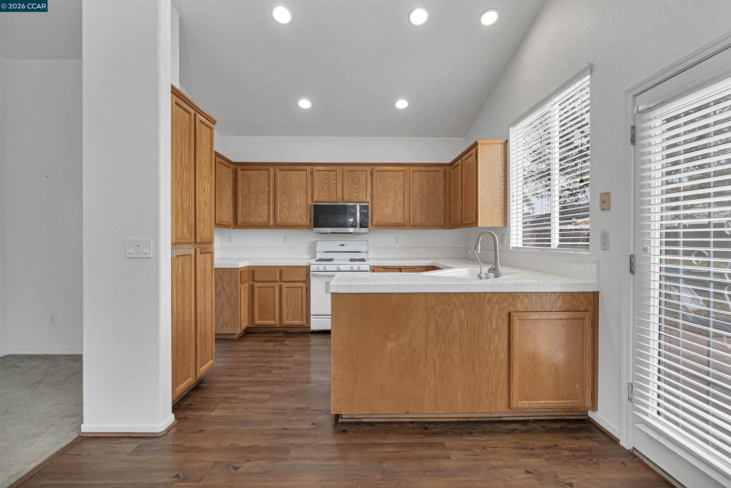 686 Anderson Way Rio Vista, CA 94571 - Photo 11 of 36 a large kitchen with stainless steel appliances granite countertop a stove a sink and a refrigerator