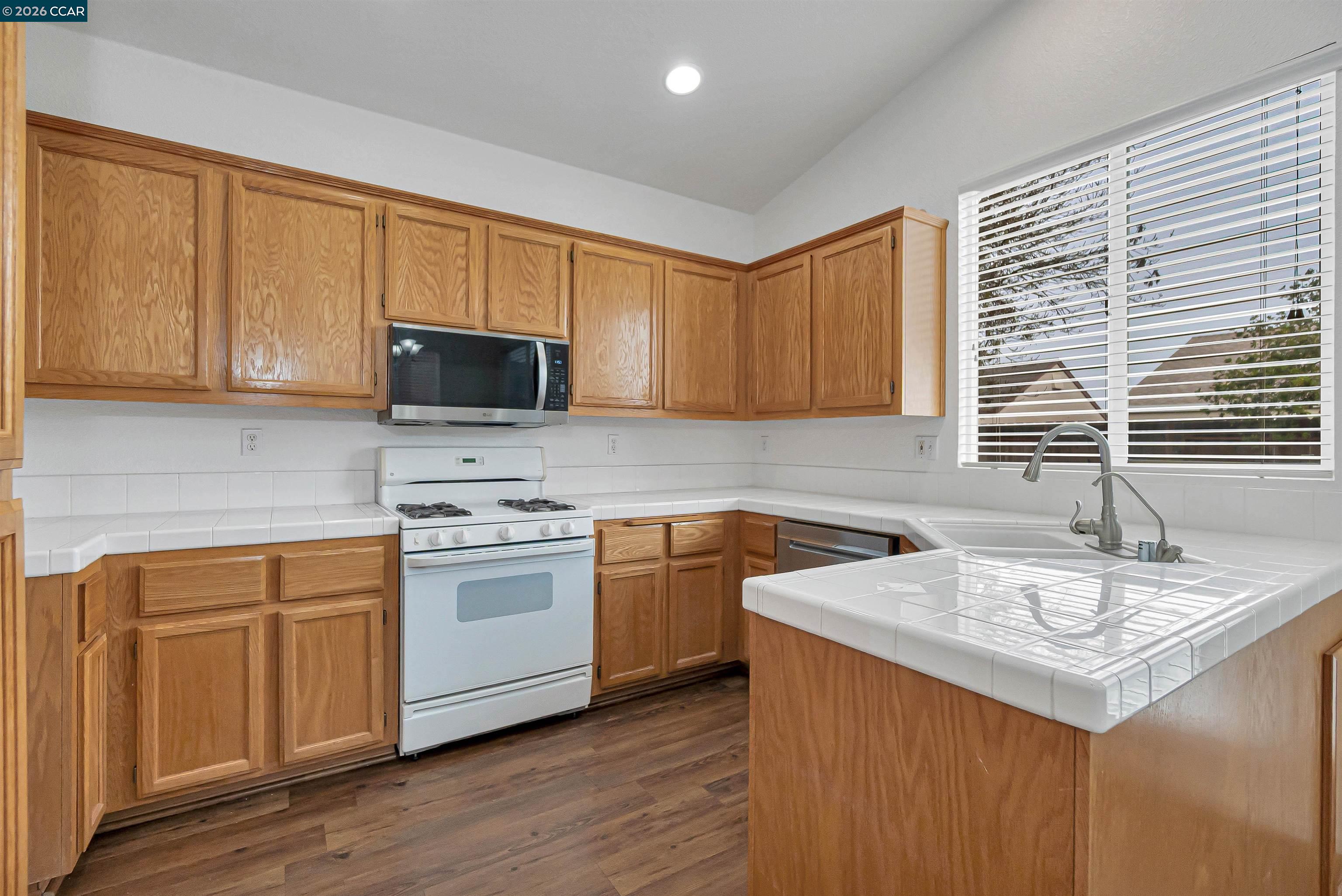 686 Anderson Way Rio Vista, CA 94571 - Photo 12 of 36 a kitchen with stainless steel appliances granite countertop a sink stove and microwave