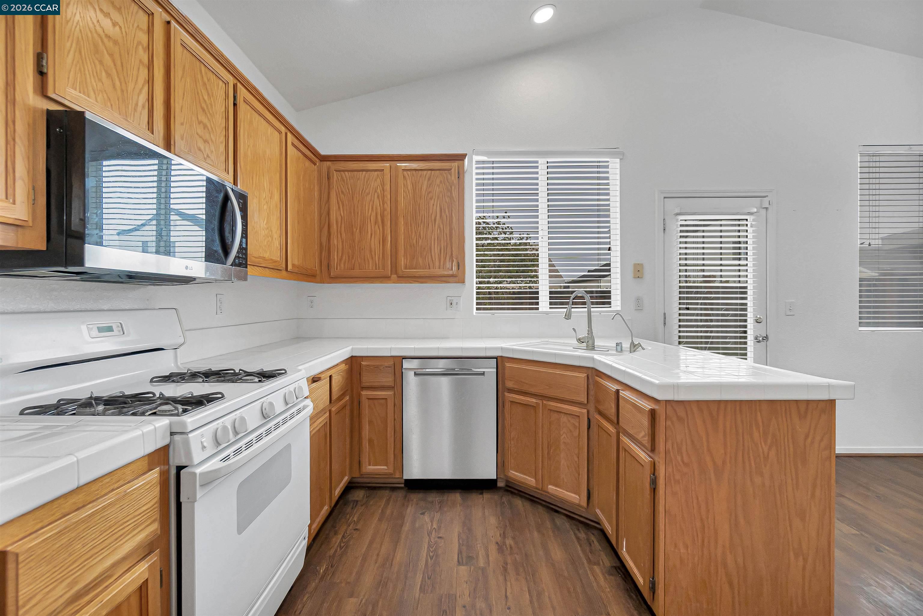 686 Anderson Way Rio Vista, CA 94571 - Photo 13 of 36 a kitchen with stainless steel appliances granite countertop a stove a sink and a microwave