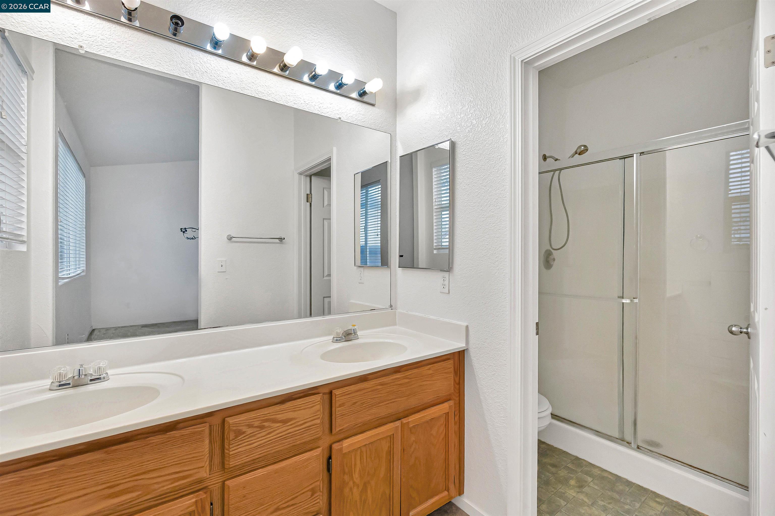 686 Anderson Way Rio Vista, CA 94571 - Photo 23 of 36 a bathroom with a double vanity sink a mirror and a shower