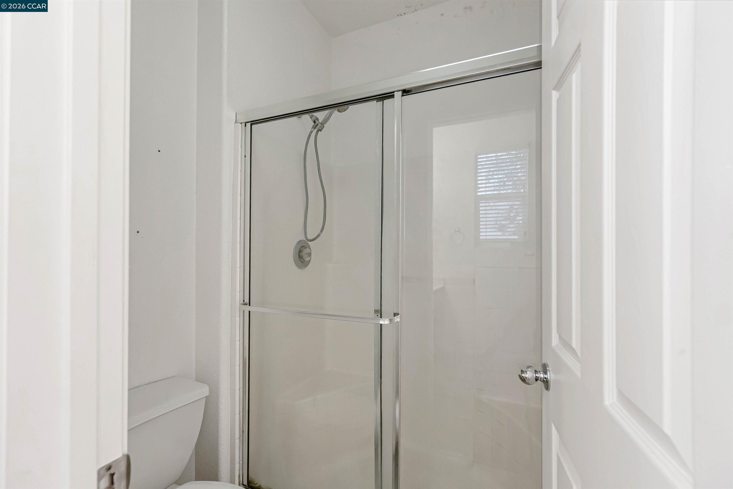 686 Anderson Way Rio Vista, CA 94571 - Photo 24 of 36 a bathroom with a glass shower door