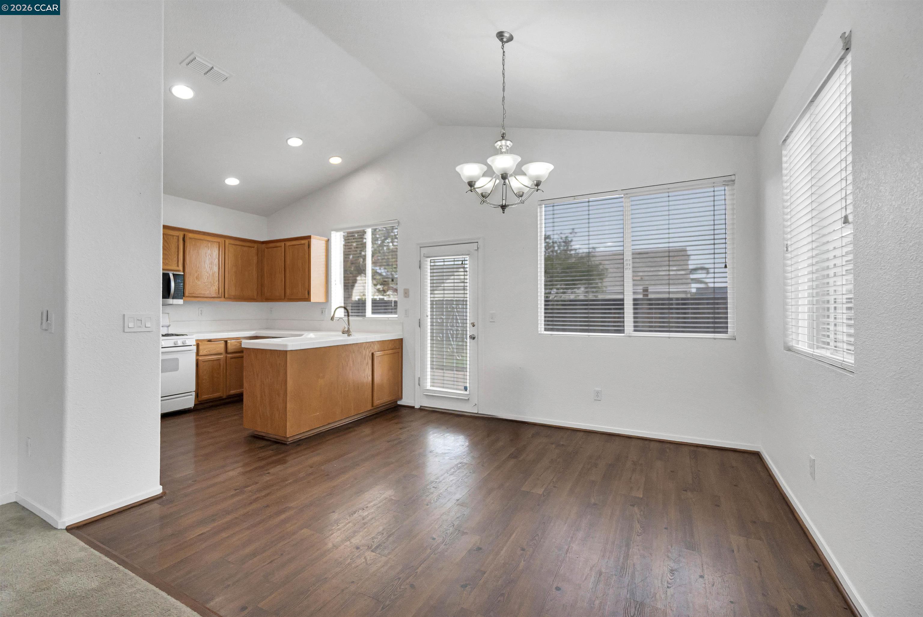 686 Anderson Way Rio Vista, CA 94571 - Photo 6 of 36 a large kitchen with stainless steel appliances kitchen island a large counter top and wooden floors