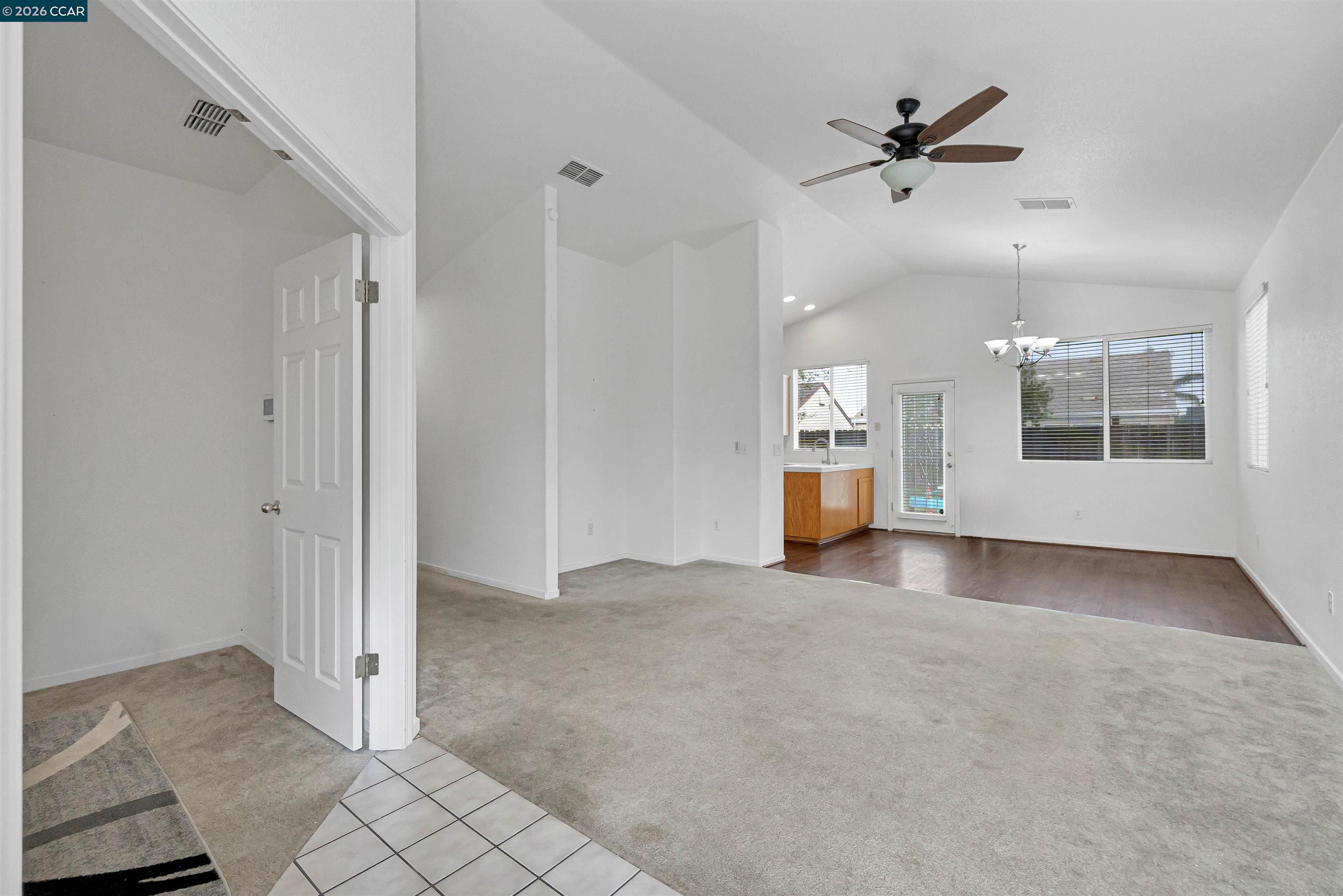686 Anderson Way Rio Vista, CA 94571 - Photo 7 of 36 an empty room with chandelier and windows