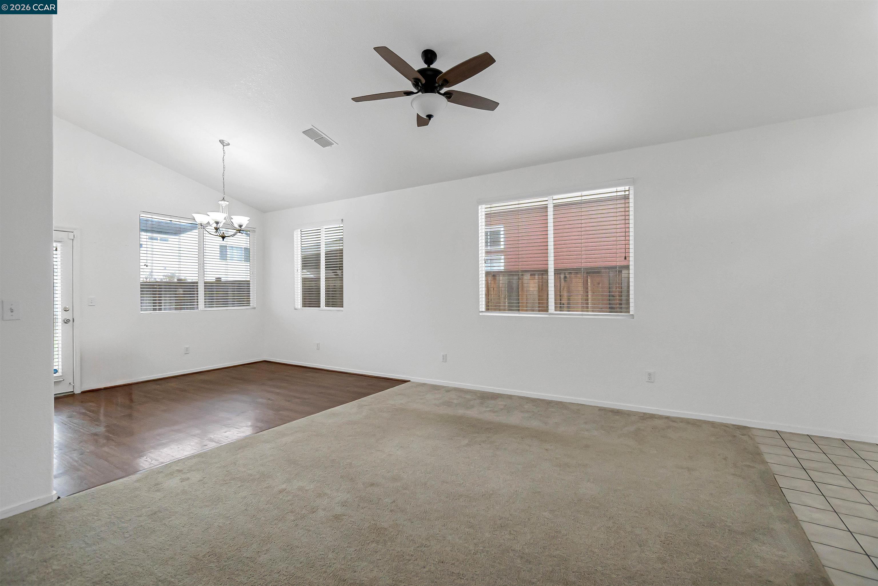 686 Anderson Way Rio Vista, CA 94571 - Photo 8 of 36 an empty room with chandelier fan and windows