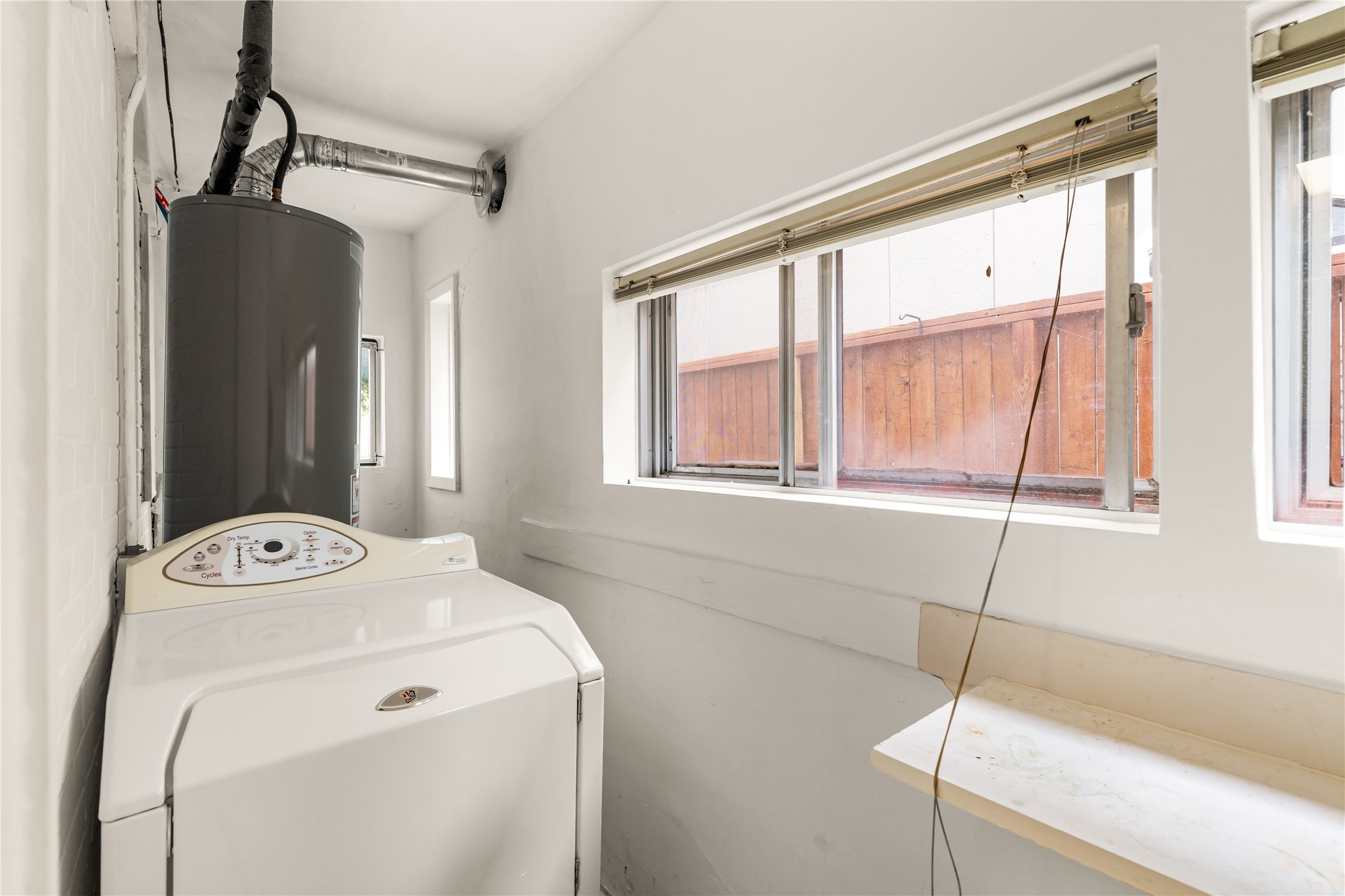 2202 West Main Street Houston, TX 77098 - Photo 14 of 32 a utility room with a window dryer and washer