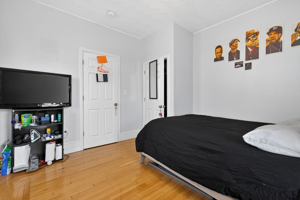 1748 North Shore Road Revere, MA 02151 - Photo 11 of 20 a bedroom with a bed and a flat screen tv