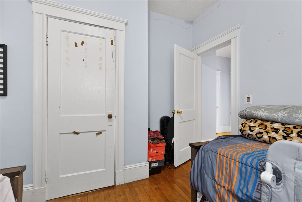 1748 North Shore Road Revere, MA 02151 - Photo 13 of 20 a bedroom with a bed and wooden floor
