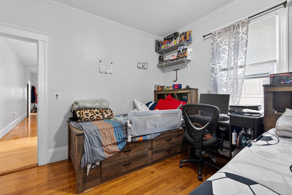 1748 North Shore Road Revere, MA 02151 - Photo 14 of 20 a bedroom with a bed and wooden floor