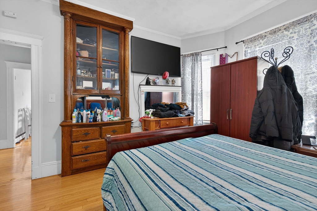 1748 North Shore Road Revere, MA 02151 - Photo 17 of 20 a bedroom with a bed and a dresser