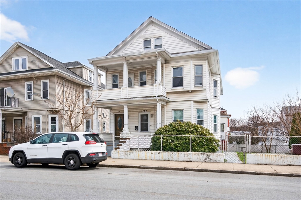 1748 North Shore Road Revere, MA 02151 - Photo 18 of 20 a car parked in front of a white house