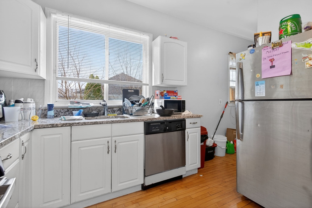 1748 North Shore Road Revere, MA 02151 - Photo 3 of 20 a kitchen with cabinets and window