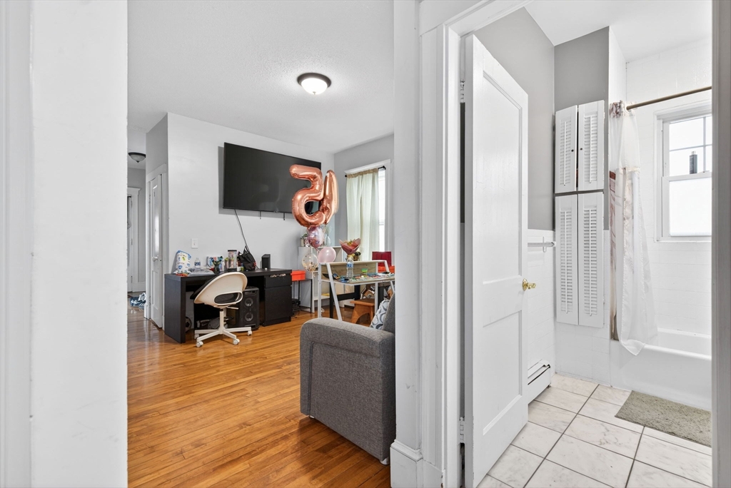 1748 North Shore Road Revere, MA 02151 - Photo 6 of 20 a living room with furniture and a flat screen tv