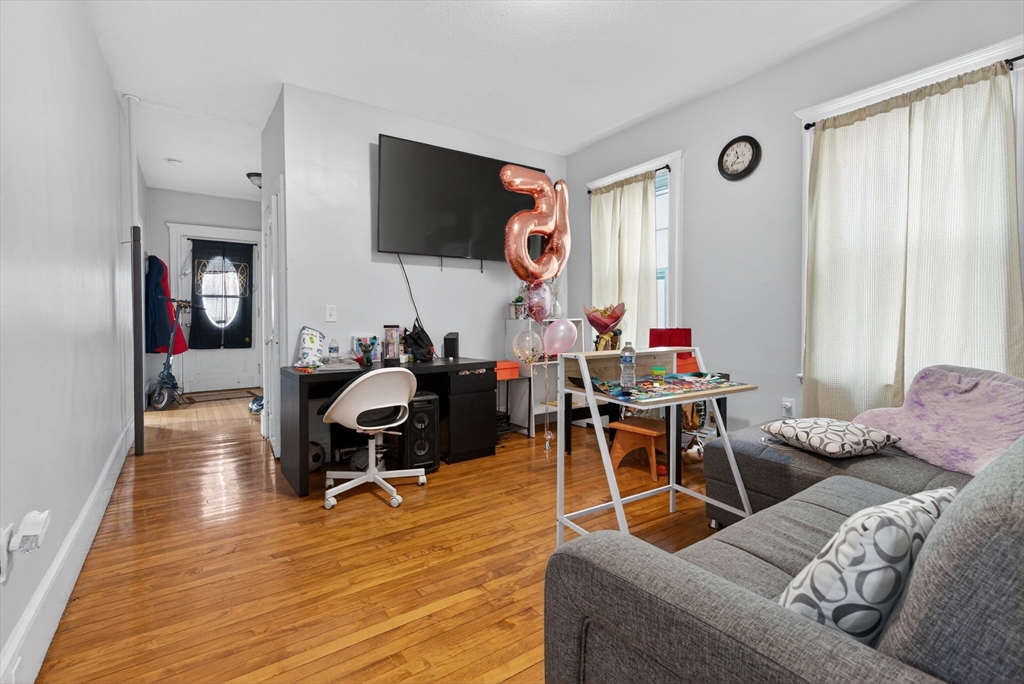 1748 North Shore Road Revere, MA 02151 - Photo 7 of 20 a living room with furniture a flat screen tv and wooden floor