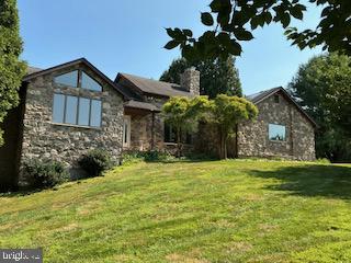 Charming stone home on lush hillside.