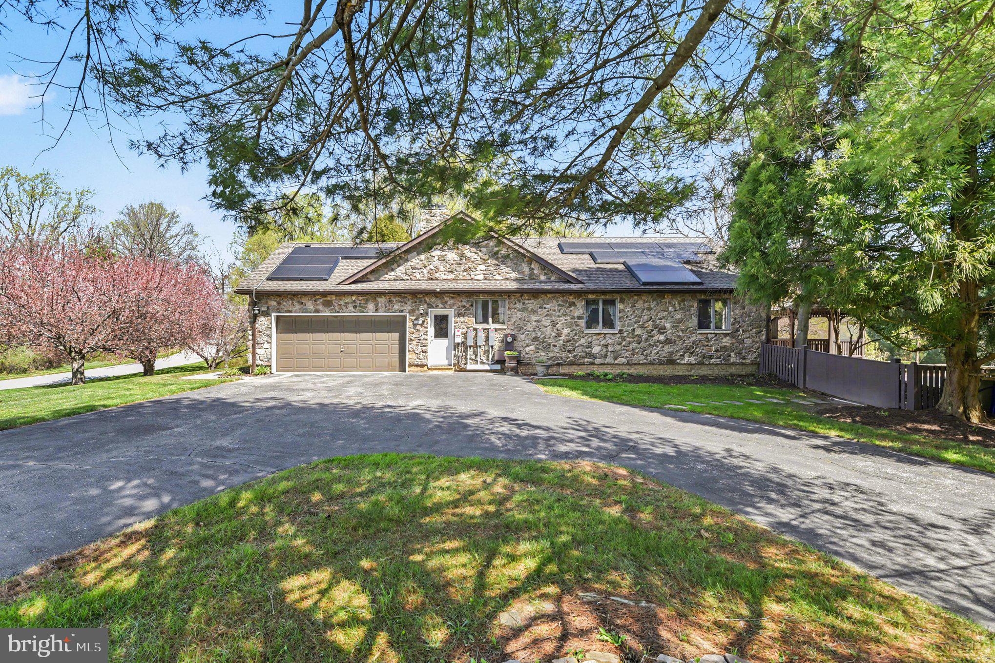 13800 Cripplegate Road Phoenix, MD 21131 - Photo 2 of 47 a front view of a house with a garden and tree