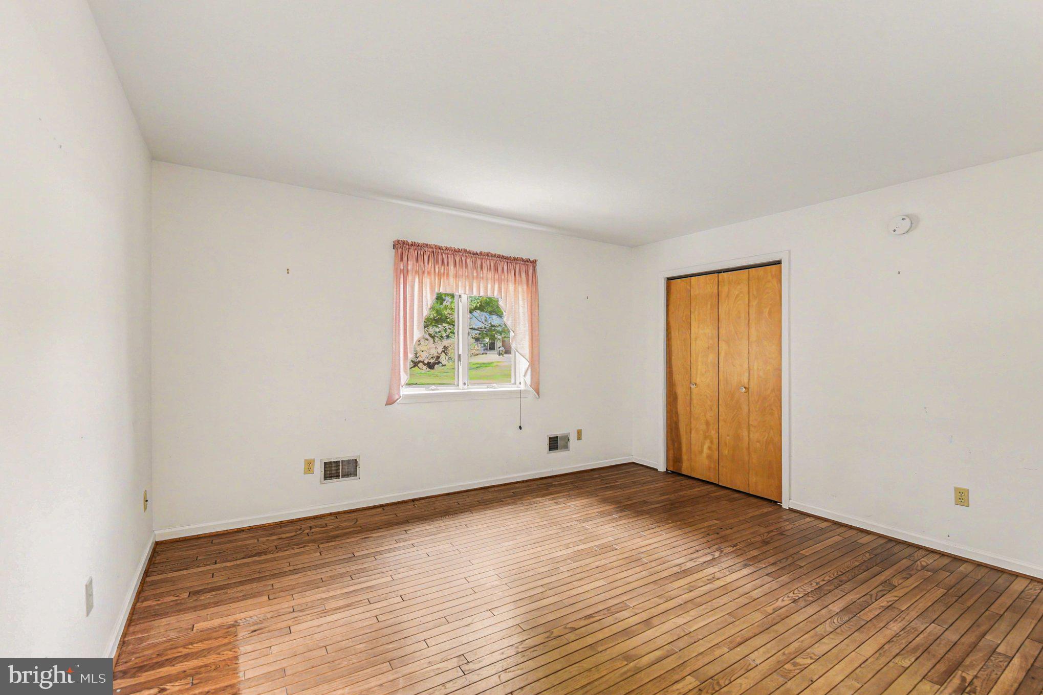 13800 Cripplegate Road Phoenix, MD 21131 - Photo 26 of 47 an empty room with wooden floor and window