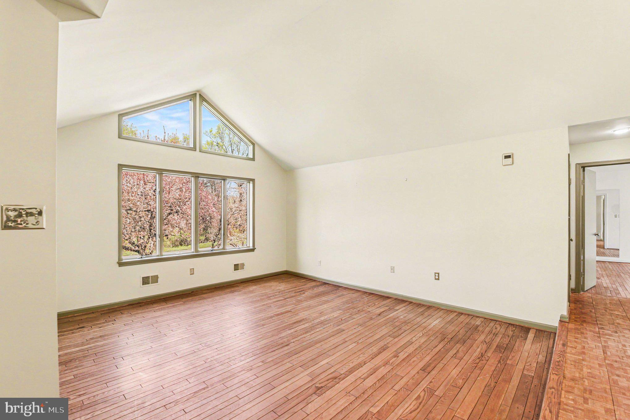 13800 Cripplegate Road Phoenix, MD 21131 - Photo 29 of 47 a view of an empty room with wooden floor and a window