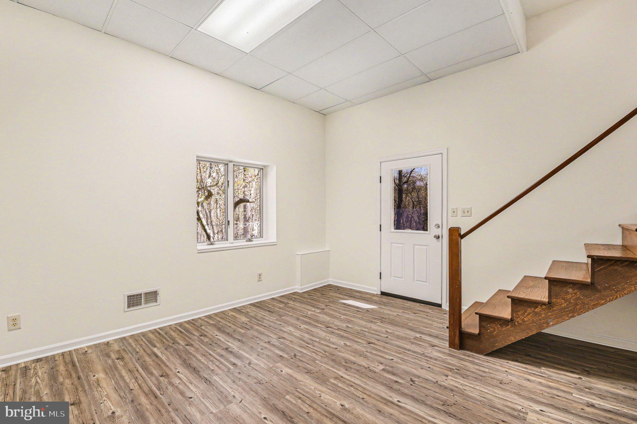 13800 Cripplegate Road Phoenix, MD 21131 - Photo 37 of 47 a view of an empty room with wooden floor and stairs