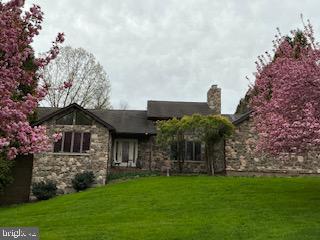 13800 Cripplegate Road Phoenix, MD 21131 - Photo 4 of 4 Charming stone home amid blooming trees.
