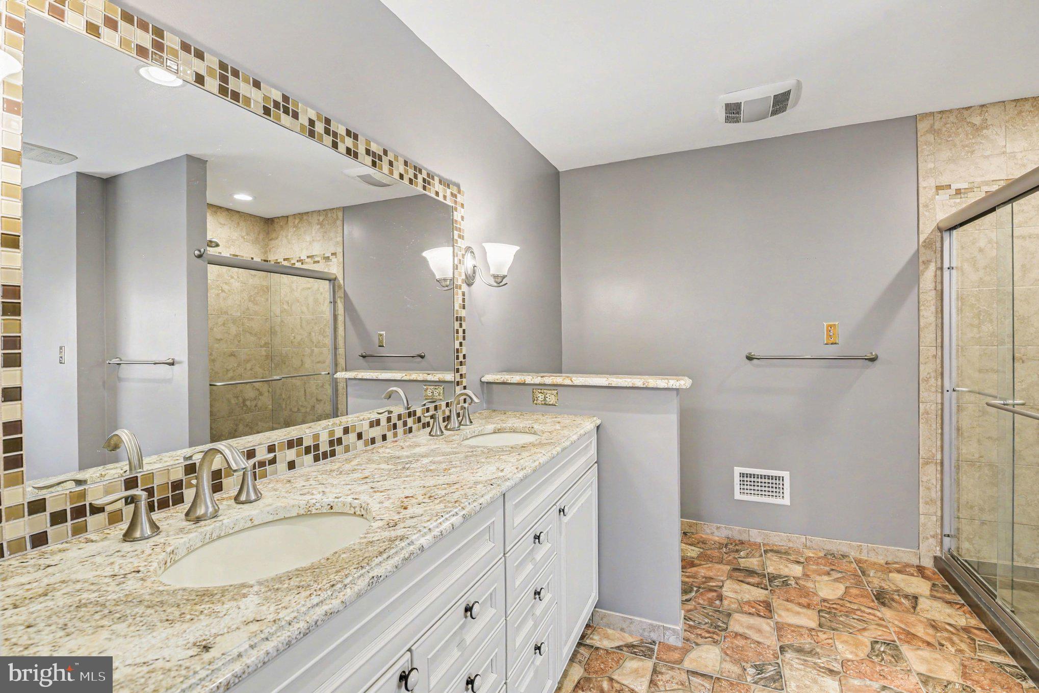 13800 Cripplegate Road Phoenix, MD 21131 - Photo 7 of 47 a bathroom with a granite countertop sink a mirror and a shower
