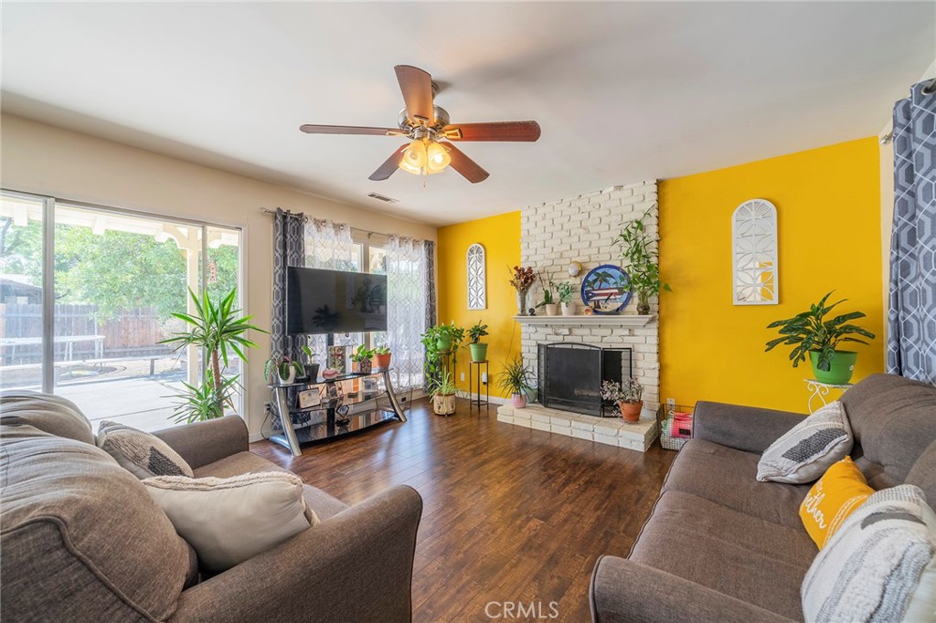 3795 San Rafael Way Riverside, CA 92504 - Photo 1 of 1 a living room with furniture a fireplace and a flat screen tv