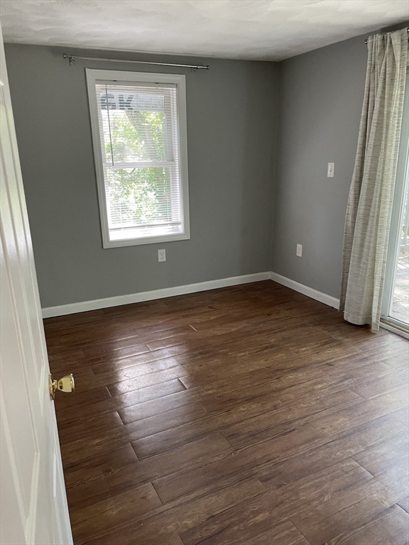 48 County Road Andover, MA 01810 - Photo 8 of 15 an empty room with wooden floor and windows