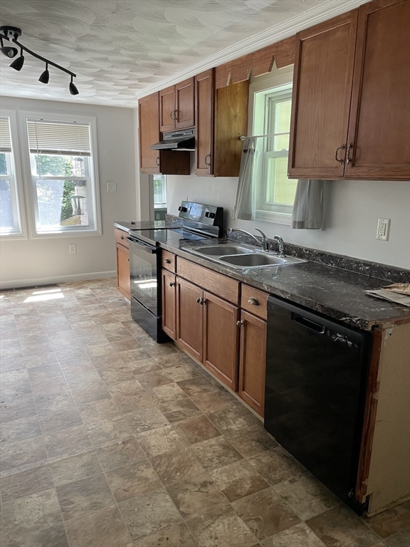 48 County Road Andover, MA 01810 - Photo 9 of 15 a kitchen with stainless steel appliances granite countertop a stove a sink and a microwave