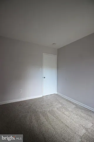 an empty room with a empty space and windows