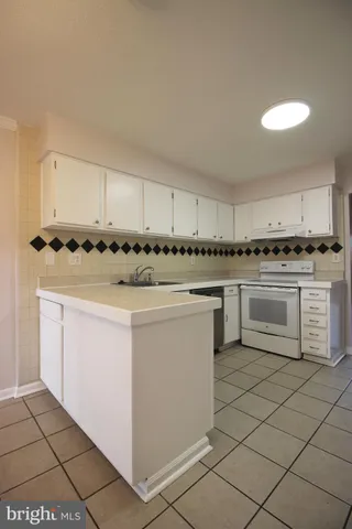 a kitchen with cabinets and white appliances