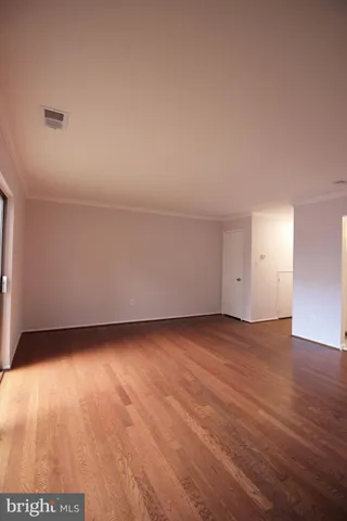 a view of an empty room and wooden floor