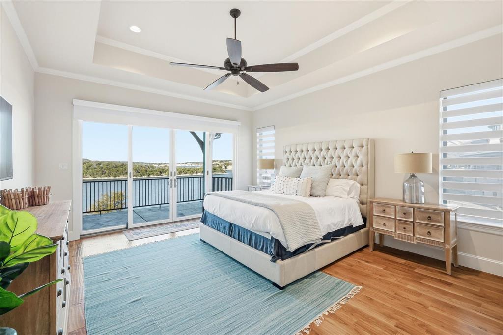 7105 West Hells Gate Drive Strawn, TX 76475 - Photo 12 of 39 a spacious bedroom with a large bed and a large window